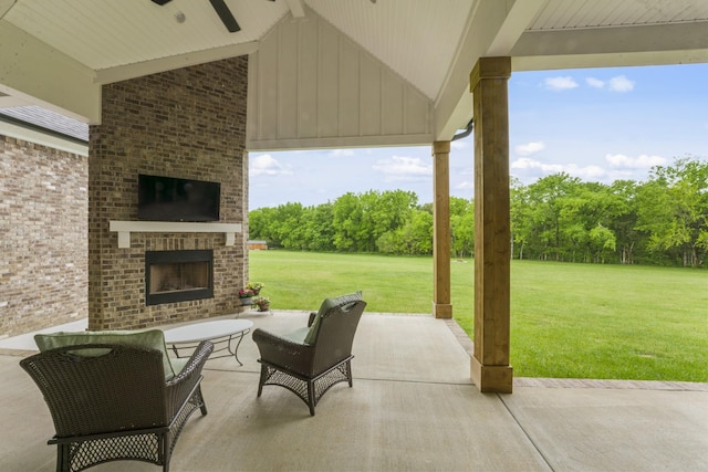 view of patio / terrace featuring an outdoor brick fireplace and ceiling fan