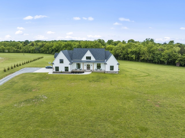 view of front of home featuring a rural view and a front lawn