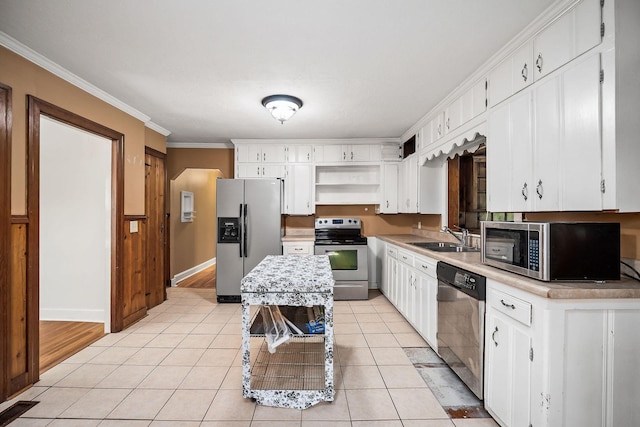 kitchen with sink, white cabinets, ornamental molding, light tile patterned floors, and stainless steel appliances