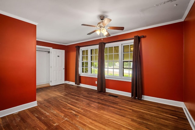 spare room with crown molding, dark hardwood / wood-style floors, and ceiling fan
