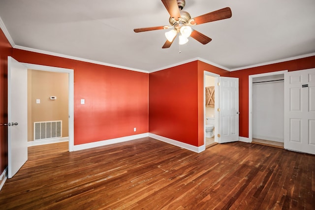 unfurnished bedroom with crown molding, ensuite bathroom, a closet, ceiling fan, and hardwood / wood-style floors