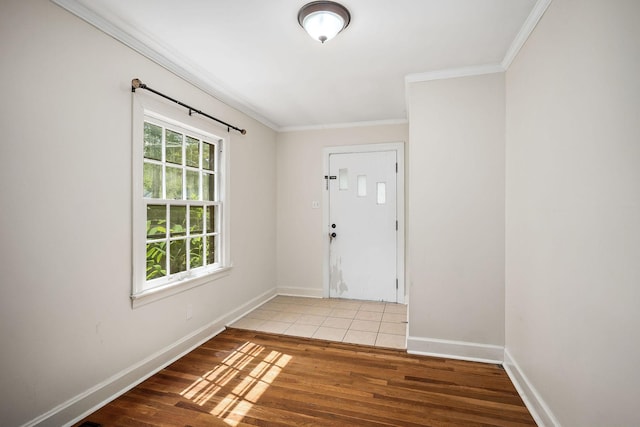 foyer with hardwood / wood-style floors and crown molding
