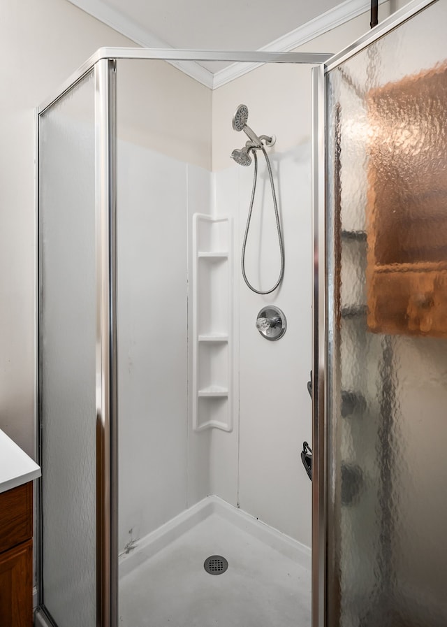 bathroom with a shower with shower door, concrete flooring, vanity, and crown molding