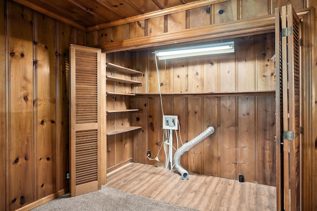 interior space with hardwood / wood-style floors, wood ceiling, and wood walls