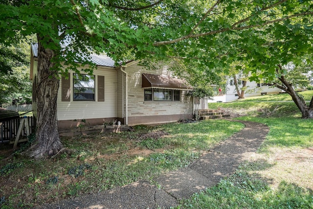 view of property exterior with a lawn