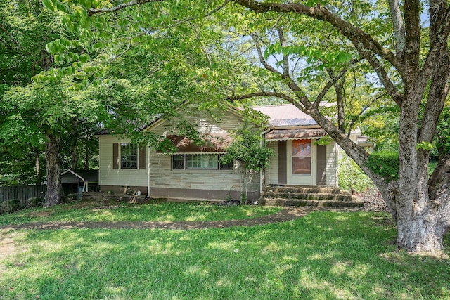 obstructed view of property featuring a front lawn