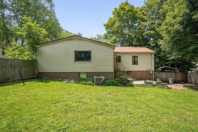 rear view of property featuring a lawn