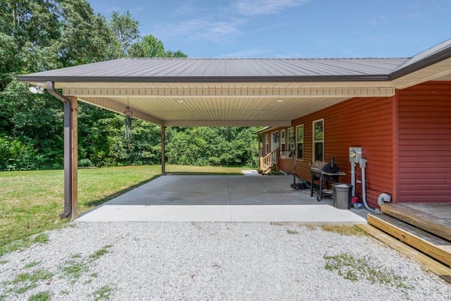 view of vehicle parking with a yard and a carport