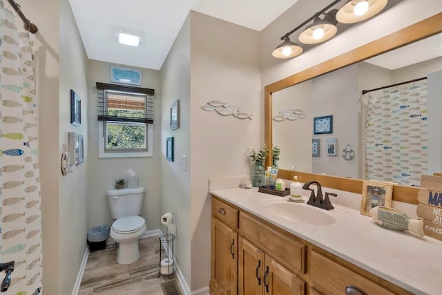 bathroom featuring walk in shower, vanity, and toilet