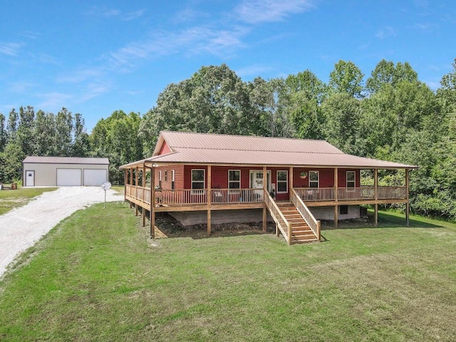 view of front facade with an outbuilding, a porch, a garage, and a front yard