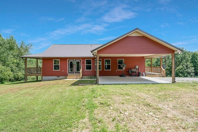 back of property with a yard and a patio