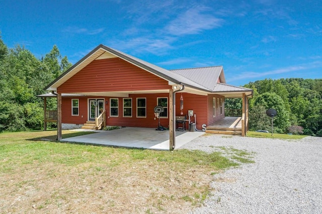 back of property featuring a yard and a patio