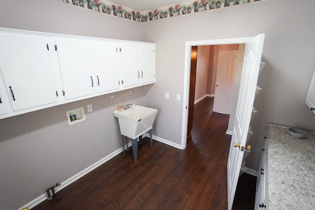 laundry area featuring hookup for a washing machine, dark hardwood / wood-style flooring, sink, and cabinets