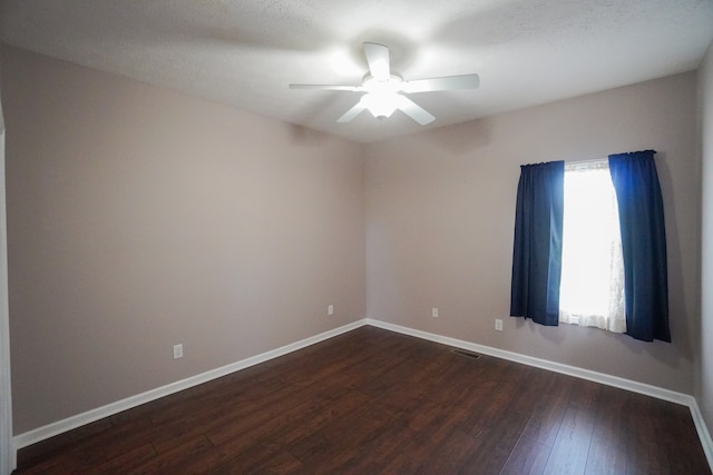 unfurnished room featuring dark hardwood / wood-style floors and ceiling fan