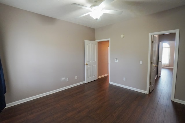 unfurnished bedroom with dark hardwood / wood-style flooring and ceiling fan