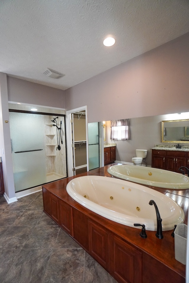 full bathroom featuring vanity, a textured ceiling, plus walk in shower, and toilet