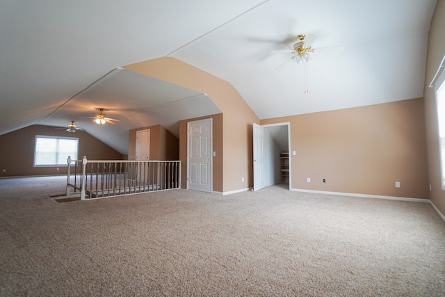 bonus room with vaulted ceiling, carpet floors, and ceiling fan