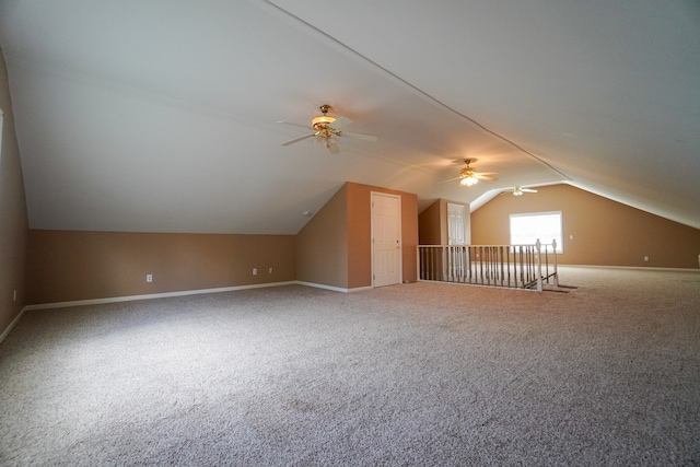 additional living space featuring carpet floors and vaulted ceiling