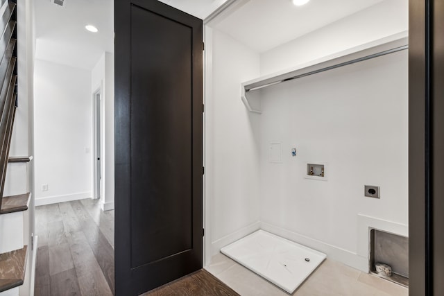 washroom with electric dryer hookup, wood-type flooring, and washer hookup