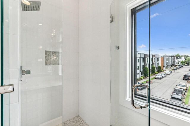 bathroom with tiled shower