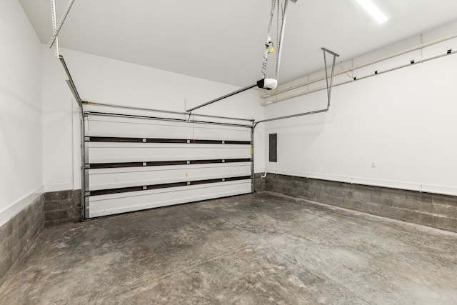 garage featuring electric panel and a garage door opener