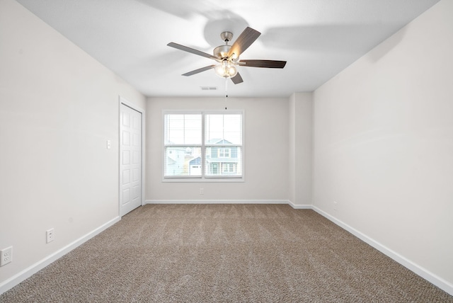 carpeted empty room with ceiling fan