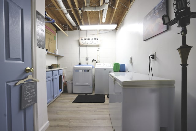 washroom featuring light wood-type flooring and separate washer and dryer