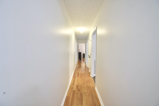 corridor featuring light hardwood / wood-style floors