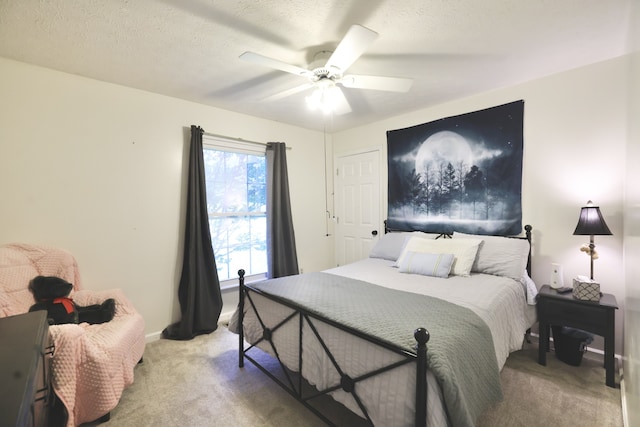 carpeted bedroom with a textured ceiling and ceiling fan