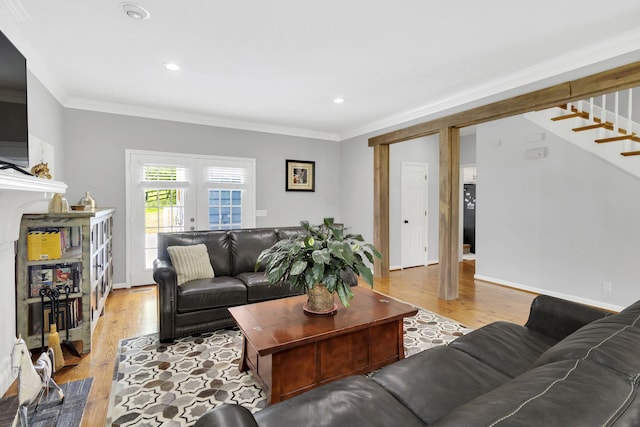 living room with light hardwood / wood-style floors and ornamental molding