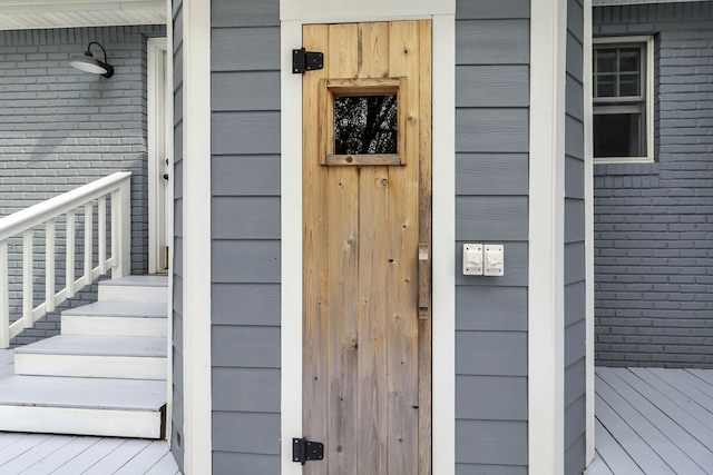 view of exterior entry featuring a wooden deck