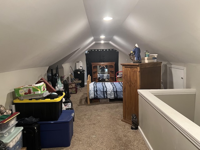 bedroom with carpet floors and lofted ceiling