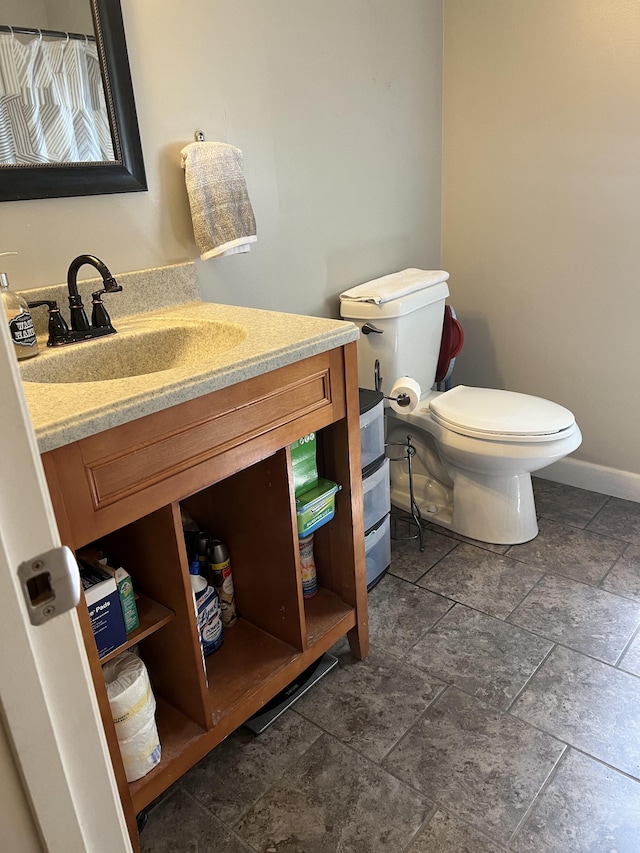 bathroom featuring tile patterned floors, vanity, and toilet