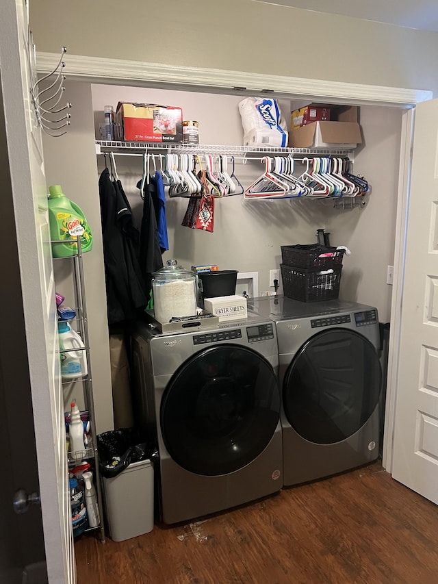 laundry room with washer and dryer and dark hardwood / wood-style floors