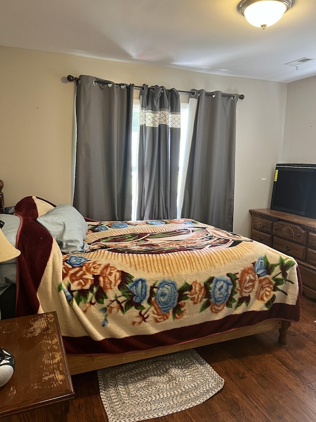 bedroom with hardwood / wood-style flooring