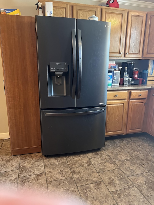 kitchen featuring black refrigerator with ice dispenser and tile patterned flooring