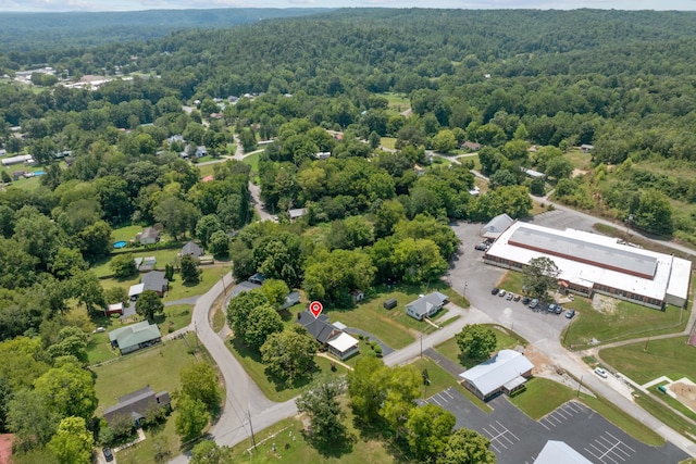 birds eye view of property featuring a view of trees