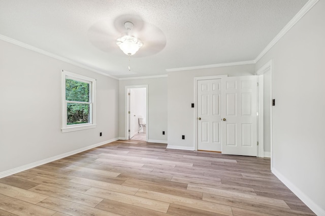 unfurnished bedroom featuring crown molding, light wood-style flooring, baseboards, and a textured ceiling