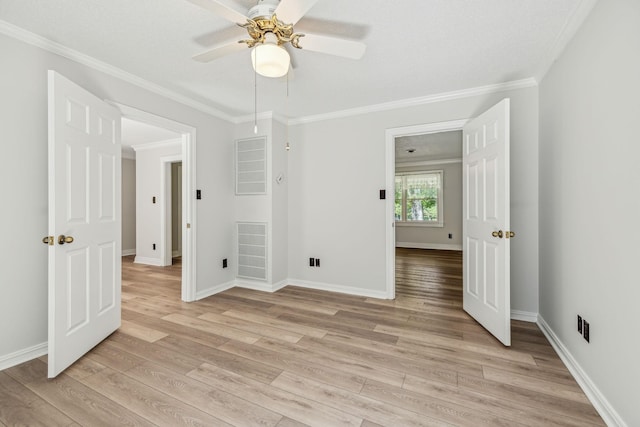 unfurnished bedroom with visible vents, baseboards, light wood-style flooring, and crown molding