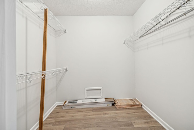 spacious closet with wood finished floors