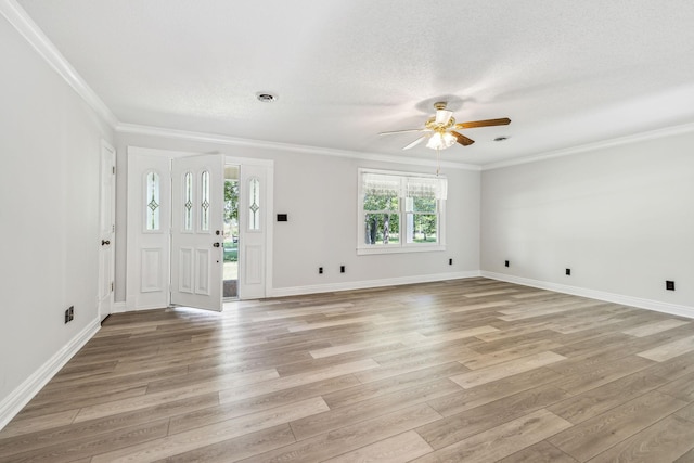 foyer featuring light wood-style floors, crown molding, and a textured ceiling