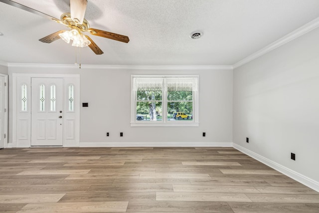 entrance foyer featuring light wood finished floors, visible vents, baseboards, and ornamental molding