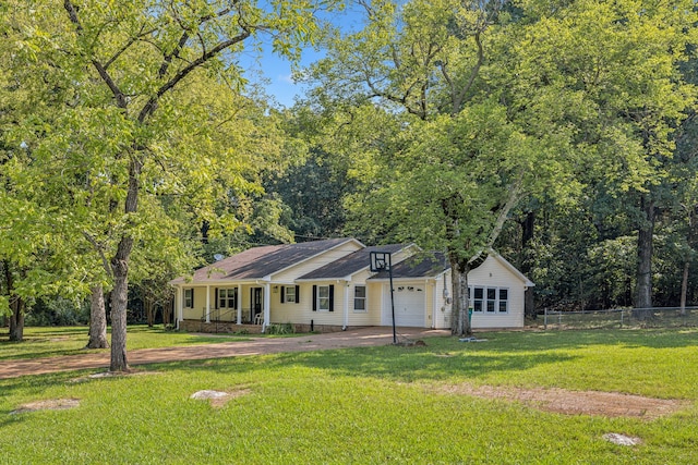 ranch-style house featuring a porch, a garage, and a front yard