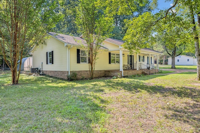 ranch-style home with a porch, fence, a front lawn, and central AC