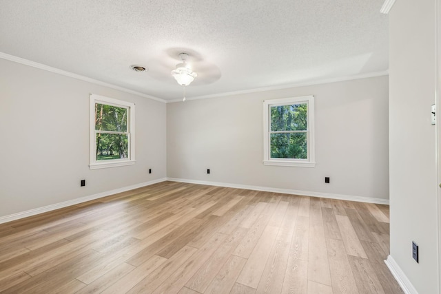 unfurnished room featuring ornamental molding, light wood-style floors, a wealth of natural light, and a textured ceiling