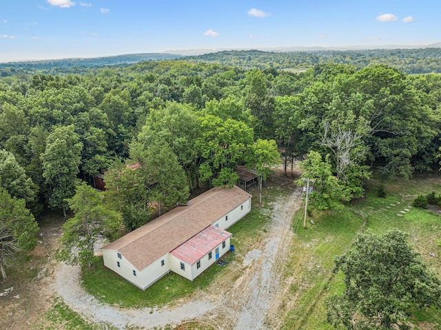 bird's eye view with a wooded view