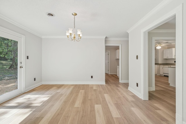 unfurnished room featuring visible vents, light wood-style floors, a healthy amount of sunlight, and crown molding