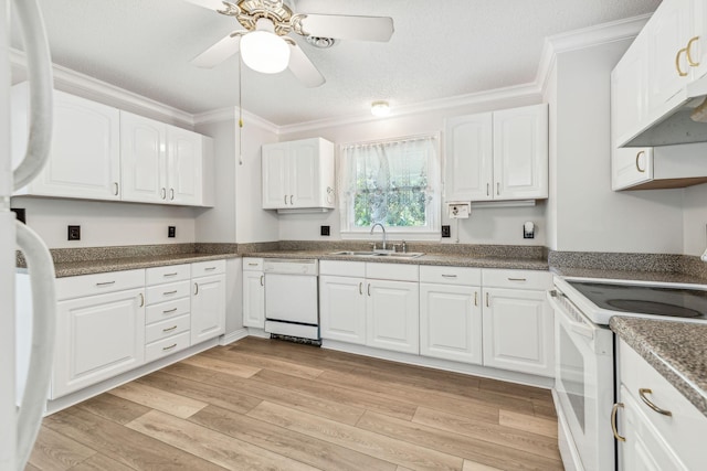 kitchen featuring light wood-style flooring, a sink, white appliances, white cabinets, and crown molding