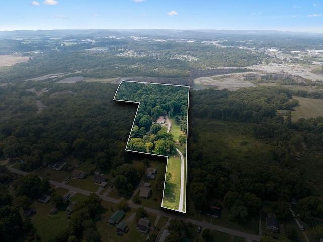 birds eye view of property with a forest view