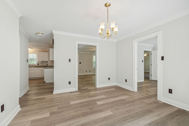 unfurnished dining area with baseboards, a healthy amount of sunlight, ornamental molding, and light wood finished floors